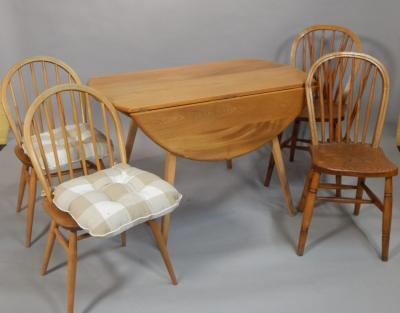 An Ercol light elm oval drop leaf table