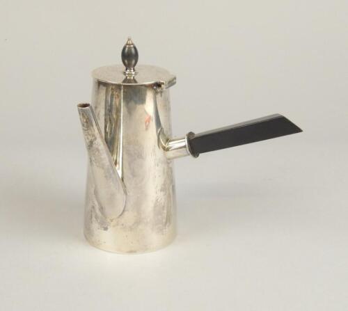 A Victorian silver chocolate pot in the manner of Dr Christopher Dresser