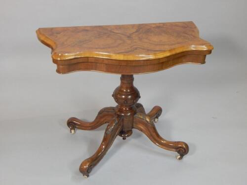 A Victorian figured walnut card table