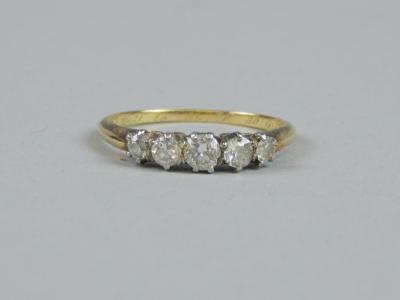 An 18ct gold five stone diamond ring