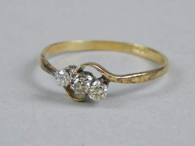 An 18ct gold three stone diamond twist ring