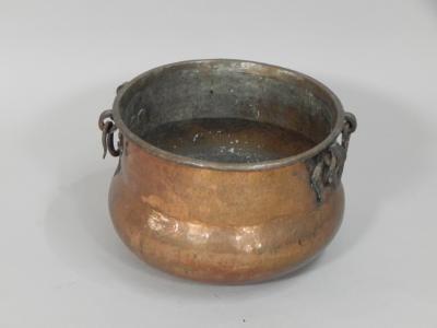 A large Eastern style hammered copper jardiniere