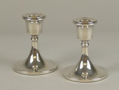 A pair of George V silver candlesticks