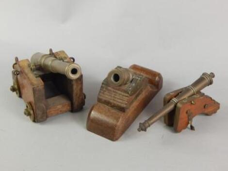 Three miniature bronze and wooden cannon