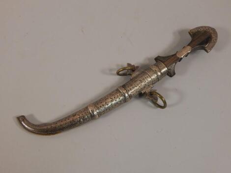 A Middle Eastern white metal and brass dagger