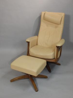 An Ercol cream leather revolving armchair