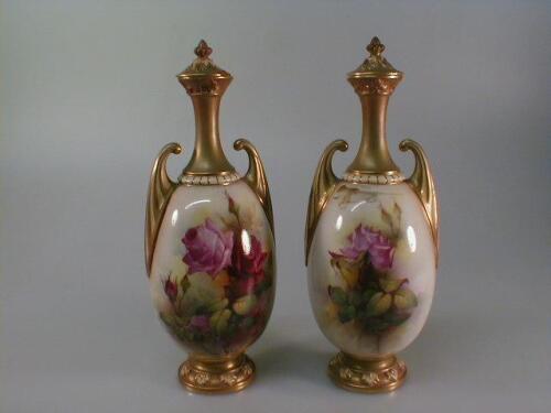 A pair of Royal Worcester ovoid two-handled vases and covers