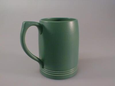 A Wedgwood pottery green ground mug by Keith Murray