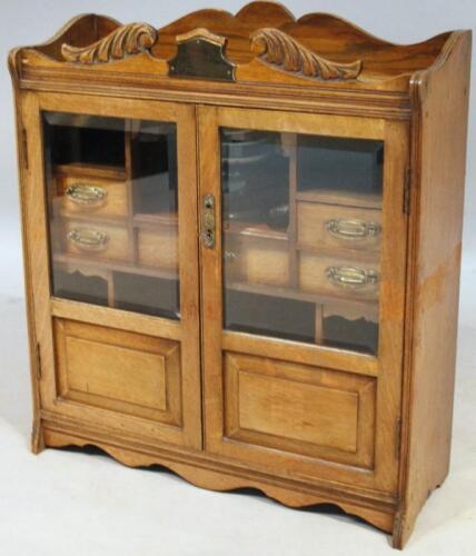 An Edwardian oak and beech smoker's cabinet