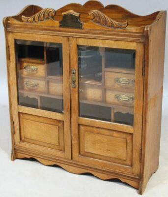 An Edwardian oak and beech smoker's cabinet