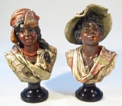 A pair of 19thC Continental Blackamoor earthenware busts of a lady and gentleman