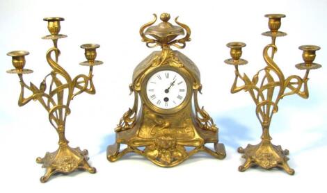 A 20thC Art Nouveau design gilt metal clock garniture