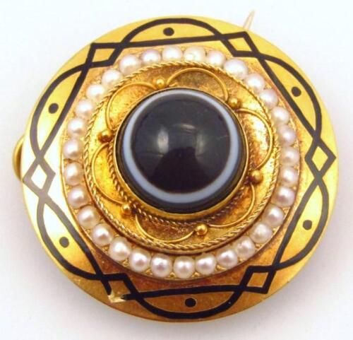 A Victorian agate cabouchon seed pearl and enamel mourning brooch