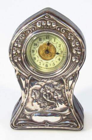 An Edwardian Art Nouveau silver mantel clock