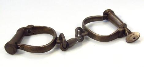 A pair of early 20thC heavy metal Hiatt handcuffs