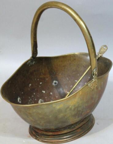 An early 20thC brass double sided helmet shaped coal bucket