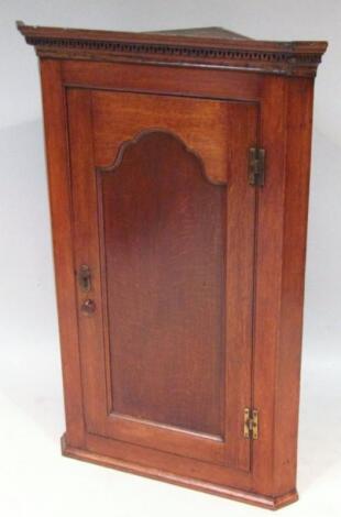 An 18thC oak hanging corner cupboard