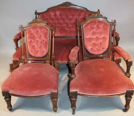 A late Victorian stained walnut three piece salon suite