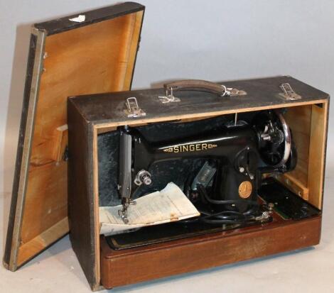 An early 20thC cased Singer electric sewing machine