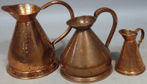 Three graduated copper harvest jugs