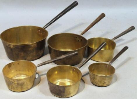 A quantity of graduated brass pans