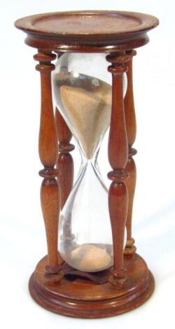 An early 20thC polished wooden egg timer