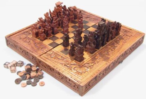 A 20thC carved hardwood and parquetry chess set