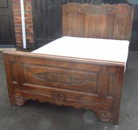 An Edwardian Bretton carved oak double bed