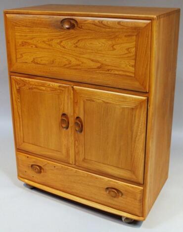 A 20thC Ercol light yew wood finish cabinet