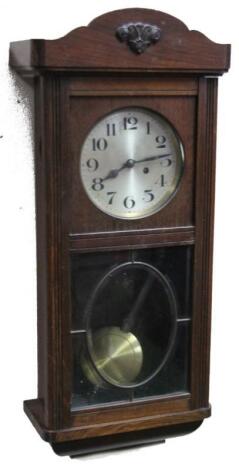 An early 20thC oak cased wall clock