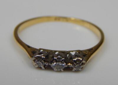 An 18ct gold three stone diamond ring