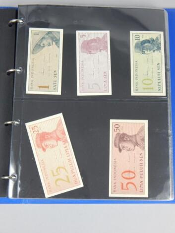 An album containing of fifty uncirculated foreign bank notes