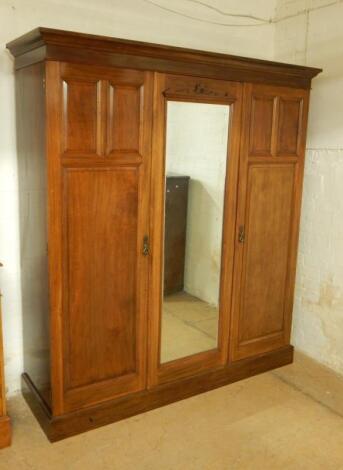 A Victorian walnut triple wardrobe