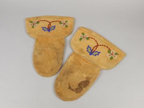 A pair of North American Indian or Canadian leather gauntlets