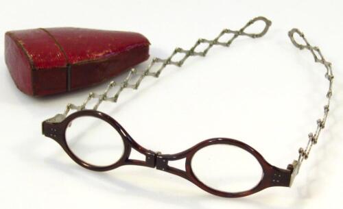 A pair of 19thC tortoiseshell and white metal folding spectacles