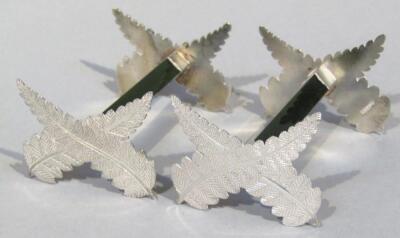 A pair of white metal and jade knife rests