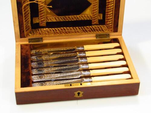 An Edwardian cased canteen of silver plated and bone handled knives and forks