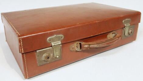 An early 20thC pressed brown leather travel case