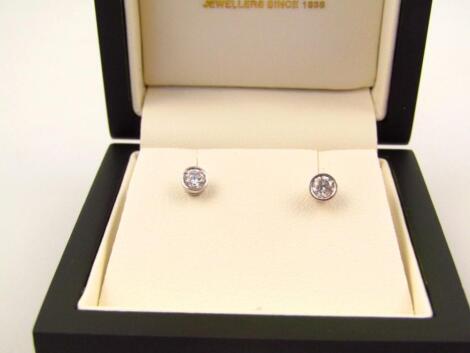 A pair of diamond set solitaire ear studs