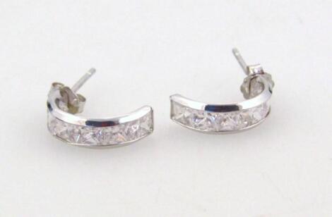 A pair of half hoop ear studs