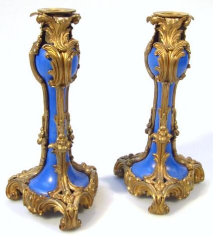 A pair of Sevres style gilt metal and blue porcelain candlesticks