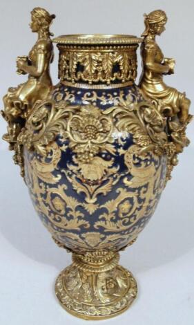 A 20thC earthenware gilt metal vase