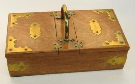 An Edwardian oak and brass bound twin section cigar and cigarette box