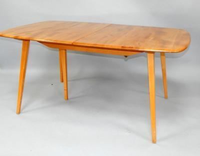 An Ercol oak and ash dining table