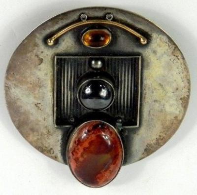 A modernist silver and gem set metamorphic pendant brooch