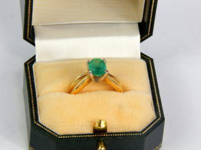 An emerald solitaire ring