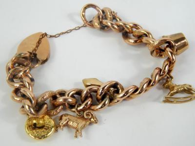 A 9ct gold curb link charm bracelet