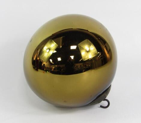 A gold glass witches ball