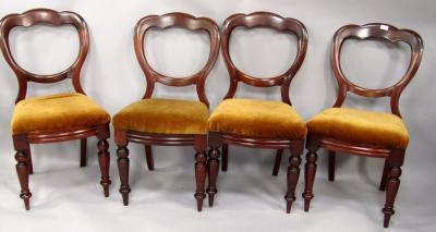 A set of four Victorian walnut balloon back dining chairs