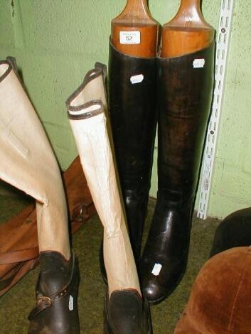 A pair of black leather riding boots